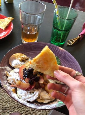 Cheese naan with pancakes in background  at Little World Kitchen in Utrecht