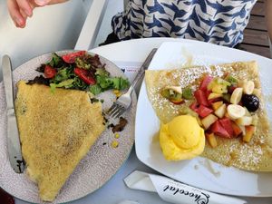 Savoury vegan crepe with mushroom, corn, vegan mayo and "cheese" (left) and sweet crepe with fruits and mango sorbet (right) at Chocolat Cafe Creperie in Naxos