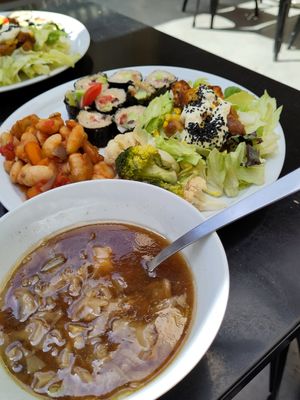 Plate of the day with mushroom-miso soup, steamed veggies marinated with extravirgin olive oil and lemon, traditionally cooked giant beans, "greek vegan sushi", Caesar salad. Fanta at Demetra in Chalkis