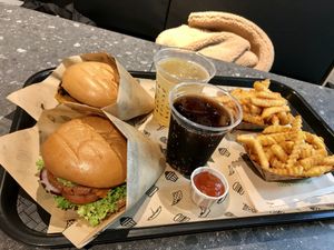 Veclassic & Veganizer burger in a menu with fries and a drink at VINCENT - Hauptbahnhof Hamburg in Hamburg