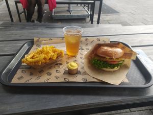 tasty burger with ice tea and fries at VINCENT - Hauptbahnhof Hamburg in Hamburg