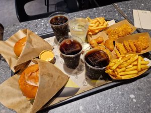 Our tray - burgers for us, nuggets for the kids, and we shared a side of chili cheese and hot cheese sauce. at VINCENT - Hauptbahnhof Hamburg in Hamburg