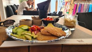 Pancakes with marinaded Tomatos, cucumber , capsicum, vegan cheese, peanutbutter , strawberries Jam and a vegan joghurt with fruits at Giorgos in Rhodes