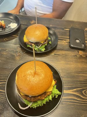 Identical homemade burgers with different toppings  at PlantPub in Cambridge
