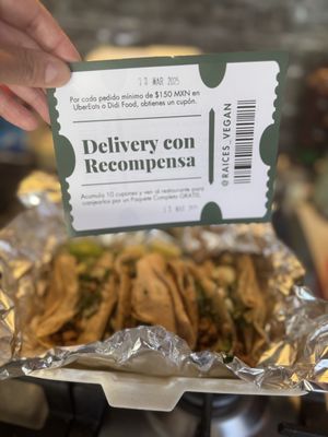 Coupon with my delivery. With 10 of these you should go to the restaurant and get a “paquete completo” (I don’t know what is that) in background the “carnitas” style soy  at Raíces in Cuautitlan Izcalli