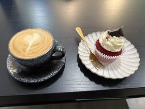 Oat milk flat white and a red velvet cupcakee  at Mudita in Auckland
