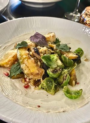 Bulgar Wheat Bowl entree - Roasted carrot, tempura squash, shaved Brussels sprouts, pomegranate and cashew ricotta at Jollity in Dayton