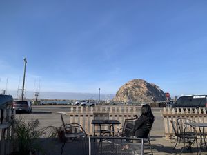 Outdoor seating with view of morro rock at Frankie & Lola's in Morro Bay