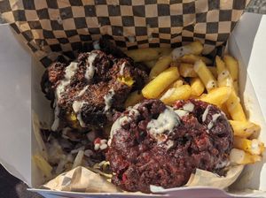 Vegetable fritters with chips, roast garlic sauce, house slaw, and dressed tomatoes at Gusto in Newquay