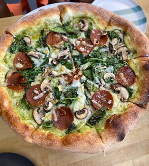 White sauce pizza with kale, garlic, mushrooms, high quality vegan pepperoni  at Thunderbolt Pizza  in Long Beach