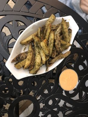 Roasted potato strips with garlic powder, yum yum sauce on the side   at Green Street Eatery in Levittown
