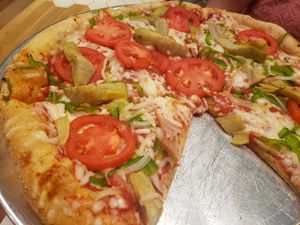 Pizza with tomato, artichoke, sweet onion, green peppers, and Follow Your Heart cheese. at Mellow Mushroom in Fredericksburg