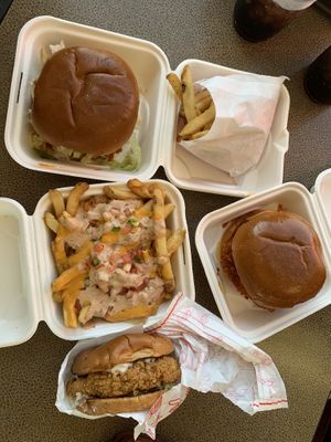 Original project sandwich, southwest style loaded papas, spicy Buffalo chikn sandwich, and Nashville hot chikn sandwich   at Project Pollo in Houston