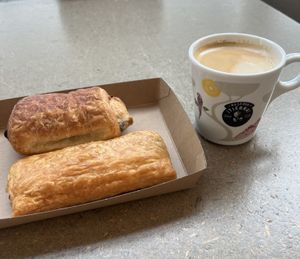 Mushroom roll and pain au chocolate with oat latte  at AMS - Amsterdam Bread Company in Schiphol