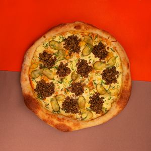 Pizza Chod with cheezy sauce base, local artisan or vegan cheese, lentil and walnut crumb, pickles and spring onion. at Color Nativo in Puerto Varas