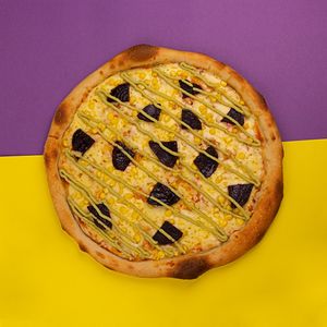 Pizza Koñoll with tomato base, local artisan or vegan cheese, sautéed beets, broad bean purée and corn. at Color Nativo in Puerto Varas