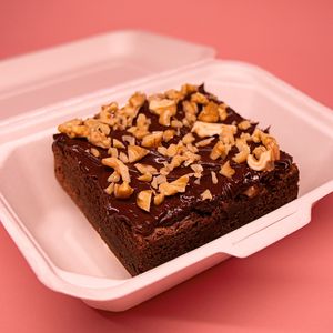 Our vegan brownie served with walnuts and dark chocolate ganache. at Color Nativo in Puerto Varas