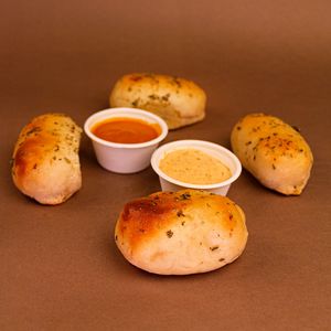 Cheese bread sticks filled with mozzarella or vegan cheese and served with house-made pomodoro sauce and spicy veganaise made with merkén (local smoked chili). at Color Nativo in Puerto Varas