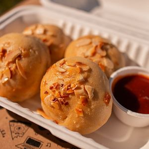 Onion rolls finished with roasted almonds and served with our bbq sauce. at Color Nativo in Puerto Varas