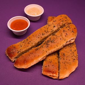 Garlic bread sticks smothered in native chilote garlic and served with house-made pomodoro sauce and spicy veganaise made with merkén (local smoked chili). at Color Nativo in Puerto Varas