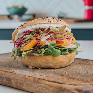 House-made bagel filled with cream cheese, smoked zalmon, cucumber, red onion, avocado and fresh beetroot and sunflower sprouts.
 at Color Nativo in Puerto Varas