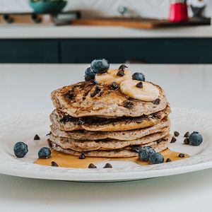 3 fluffy banana and belgium chocolate pancakes, blueberries and agave syrup. Optional addition of natural peanut butter.
 at Color Nativo in Puerto Varas