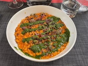 Risotto al pomodoro, olive e capperi, cipolla agrodolce e pesto di basilico  at Cerchio Rosso in Cagliari