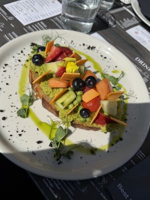 Avocado toast with vegetables, fruits, and vegan cheese   at EK Bistro in Ljubljana