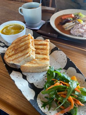 Tempeh sambal sandwich (front), Fermented curry with grilled vegetables (back). at Qyun Fermented Cafe 큔 in Seoul