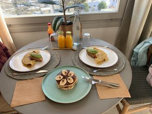 Vegan breakfast: Freshly squeezed orange juice, homemade bread with avocado, chickpea flour "omelette" with mushrooms & hazelnut chocolate pancakes with banana at Mod Santorini in Santorini