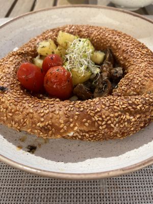 Bagel with smoked tofu-bacon, with roasted potato cubes and vegetables  at Mod Santorini in Santorini