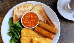 The vegan breakfast (mushrooms and tomato swapped for an extra hash brown), also vegan hot chocolate in the corner   at The New Society in Devizes