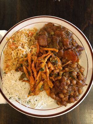Clockwise from bottom left = Basmati Rice; Vegetable Fried Rice; Garden Vegetable Curry; Chana Masala. Middle = Mixed Vegetable Pakora at The Hyderabad Indian Grill in Bloomington