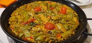 Paella time! Beans, tomatoes, artichokes, and more. at La Paella de la Reina in Madrid