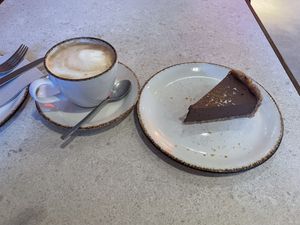 Café con leche + tarta de chocolate y naranja   at Naked & Sated in Bilbao