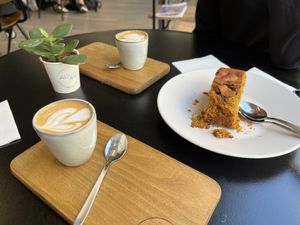 Cortado with Oat milk and pumpkin cake  at Arvo Specialty Coffee (Guggenheim) in Bilbao