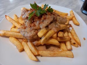 Loaded papas. Heura en salsa de vino y cebolla. at Vida Cafe in Barcelona