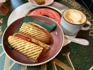 Pastrami panini and oat latte   at Nonna's Deliciously Different in Swansea