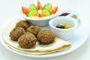 Palestinian set: Hummus with olive oil, tomato and cucumber, 5 falafels, Za'atar, Sumak, Arabic bread (or rice), olives. at Najadacze.pl - Vege Kuchnia Swiata in Wroclaw
