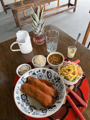Cabbage pancake filled with red and white quinoa, and carrots. Whole-grain rice, beans, salad and ‘farofa’  at Cuca Alimentos in Salvador