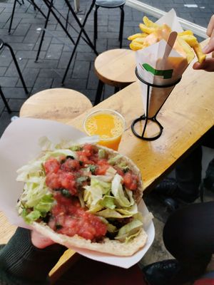 Fried mushroom pita with salad and sauces of your choice, fries and fresh orange juice. So good! at Maoz - Damrak in Amsterdam