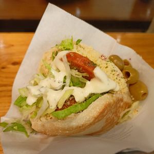 Falafel hummus pita with garlic sauce at Maoz - Damrak in Amsterdam