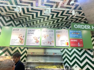 Sign shows price for extra ingredients, but it didn’t work that way.   at Maoz - Damrak in Amsterdam