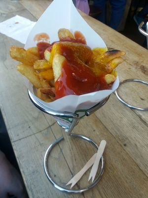Fries with ketchup and amba sauce at Maoz - Damrak in Amsterdam