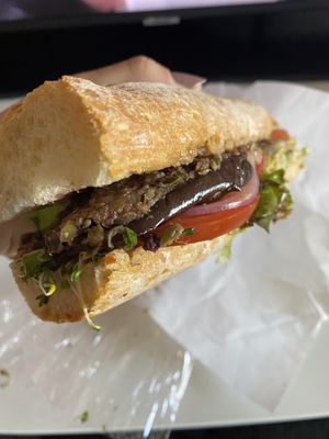 Baguette with olive tapenade, sprouts, carrots, lettuce, tomato, onion, eggplant  at City Market in Burlington