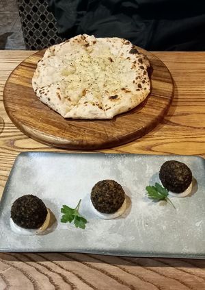 Vegan garlic bread with cheese and truffle arancini with vegan mayo at Lombardi's in Chesterfield