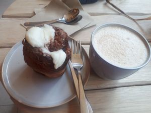 Cappuccino and a cinnamon roll. at Taylor's Cafe in Brussels