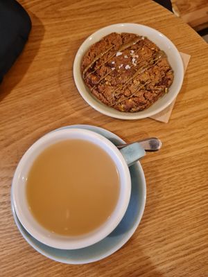 Pistachio cookie and hot ginger drink at Taylor's Cafe in Brussels