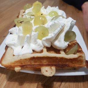 Vegan waffle with whipped cream and fruit at Lody Daktyl Cafe in Gdansk