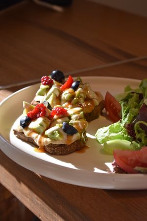 Gluten-free toast with hummus and avocado with side salad at Steppe Healthy and Vegan Bakery, in Lviv